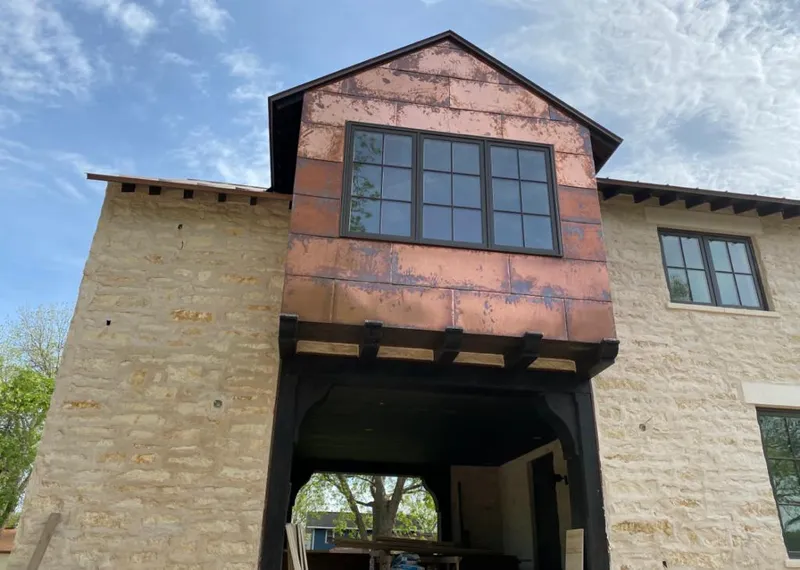 Copper metal panel facade on a stone building for Metal Roof Coating in Peru